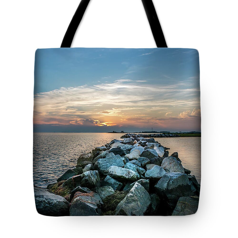 Rocks Tote Bag featuring the photograph Sunset over a rock jetty on the Chesapeake Bay by Patrick Wolf