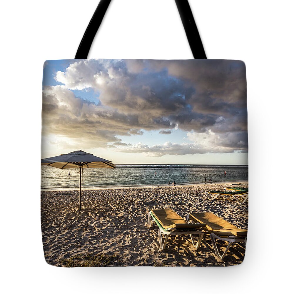 Africa Tote Bag featuring the photograph Sunset over Flic en Flac beach in Mauritius. by Didier Marti
