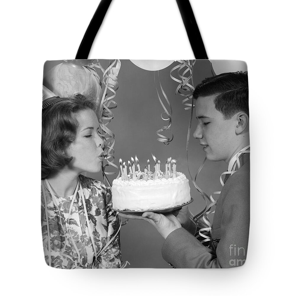 1960s Tote Bag featuring the photograph Teen Girl Blowing Out Birthday Candles by H. Armstrong Roberts/ClassicStock
