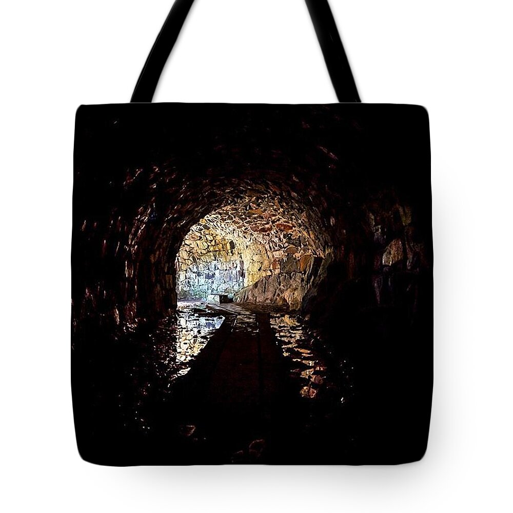  Tote Bag featuring the photograph The Damp And Gloomy Underbelly Of The by Callum Macbeth