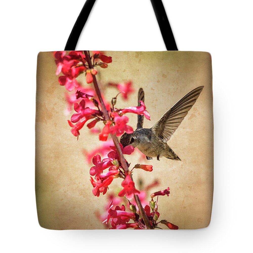 Hummingbird Tote Bag featuring the photograph The hummingbird and the Spring Flowers by Saija Lehtonen