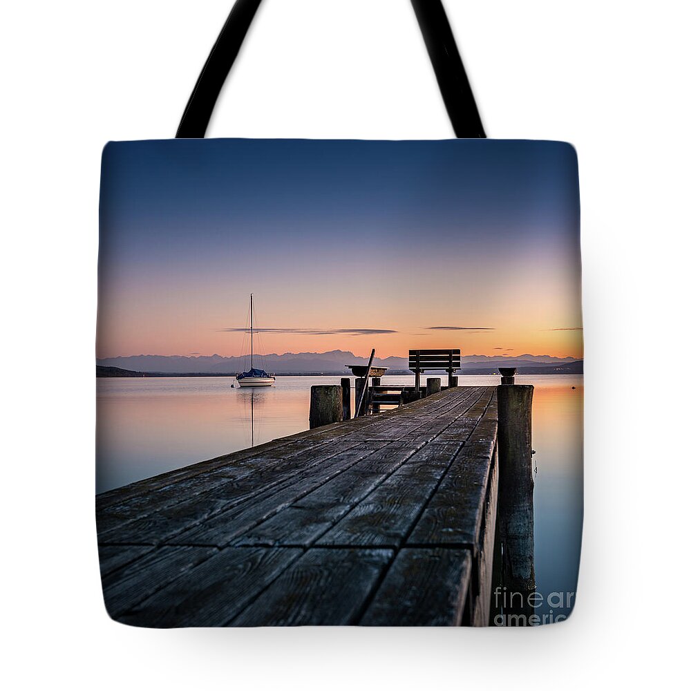 Ammersee Tote Bag featuring the photograph The jetty to sunset by Hannes Cmarits