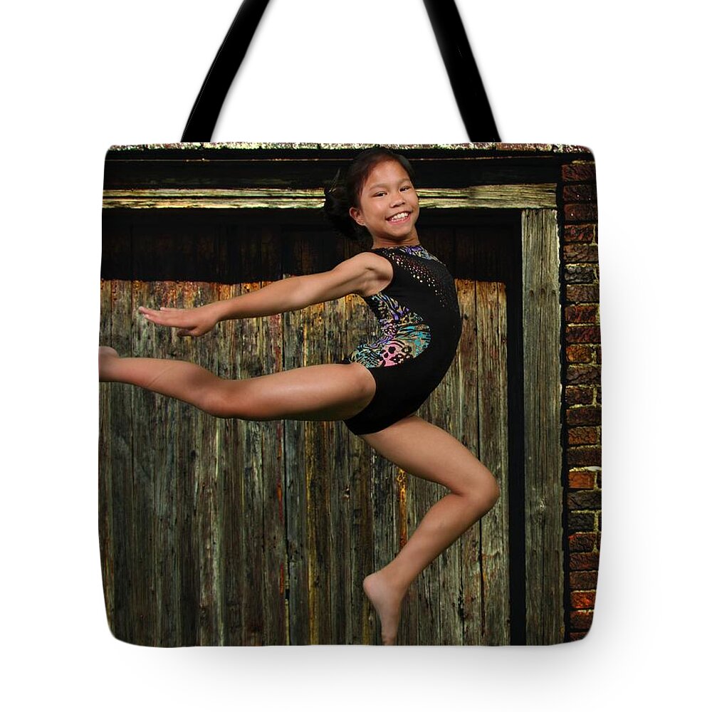 Gymnastics Tote Bag featuring the photograph The Jump by Robert Hebert