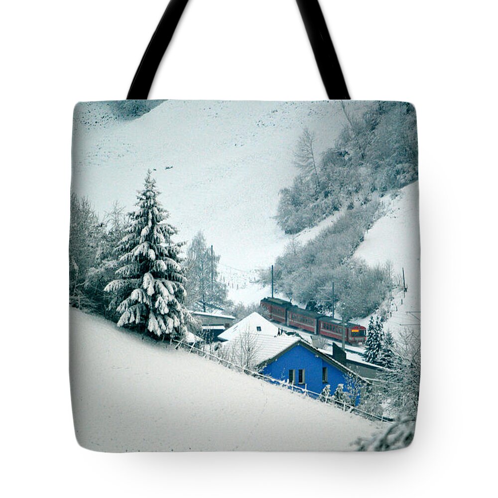 The Little Red Train Tote Bag featuring the photograph The little red train - Winter in Switzerland by Susanne Van Hulst