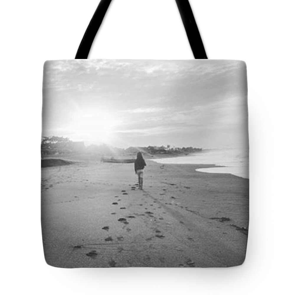 Black And White Tote Bag featuring the photograph Walking on The Beach by Maria Marganingsih