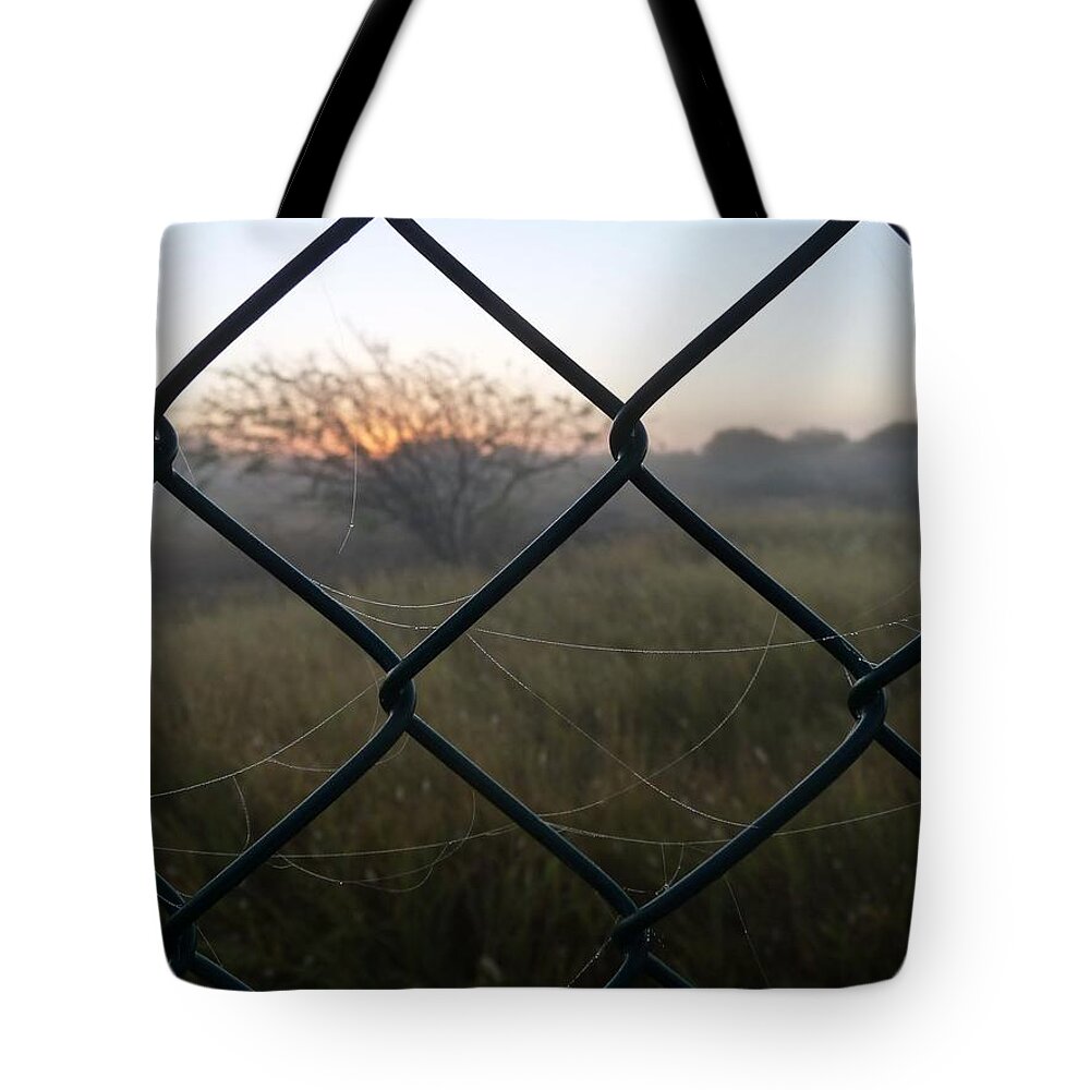 #fence Tote Bag featuring the photograph The Outlander by Jeremy Holton