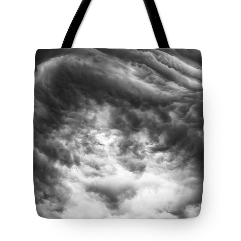 Storm Clouds Tote Bag featuring the photograph The push back by Charles McCleanon