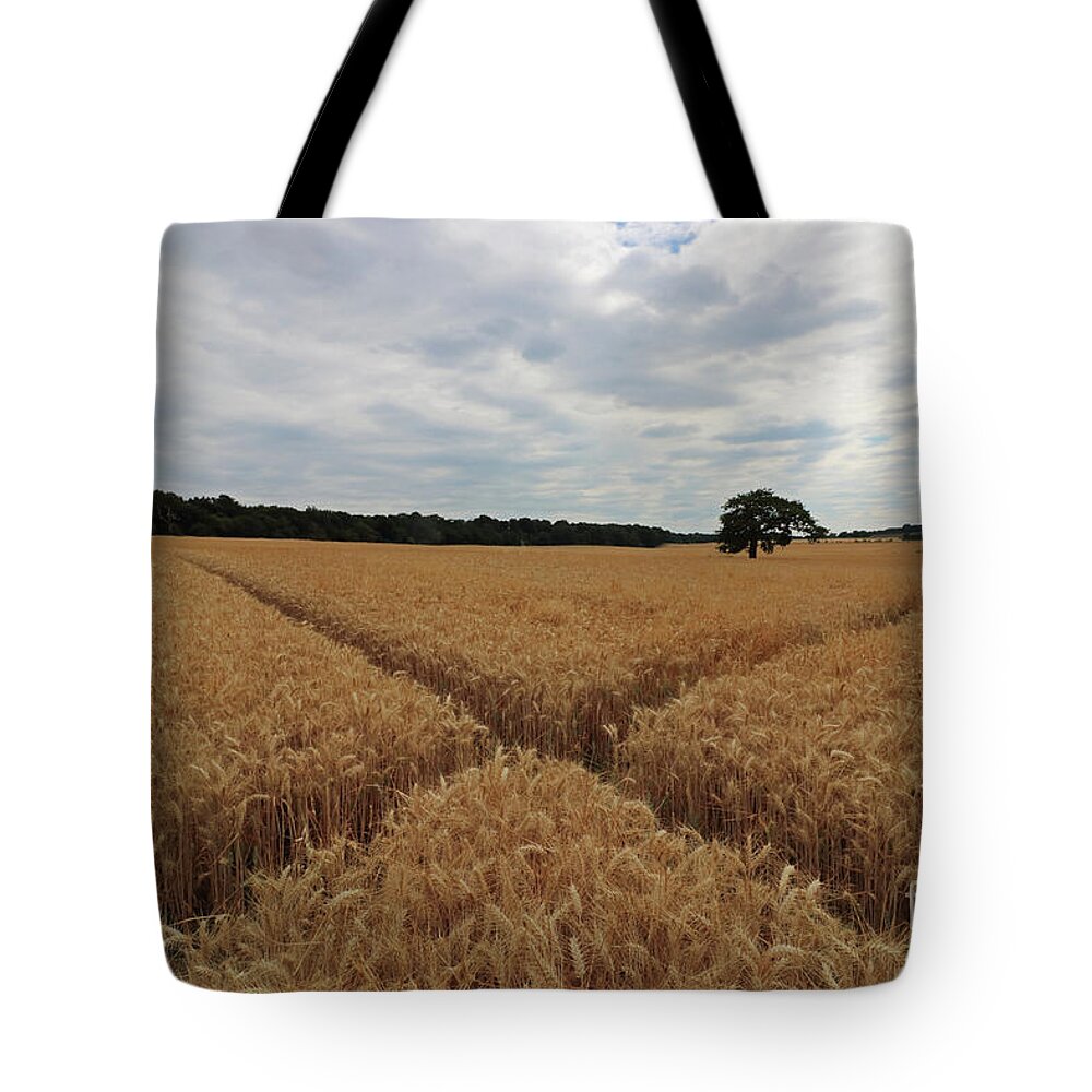 The Wheat Cross Overcast Skies Tote Bag featuring the photograph The wheat cross by Julia Gavin