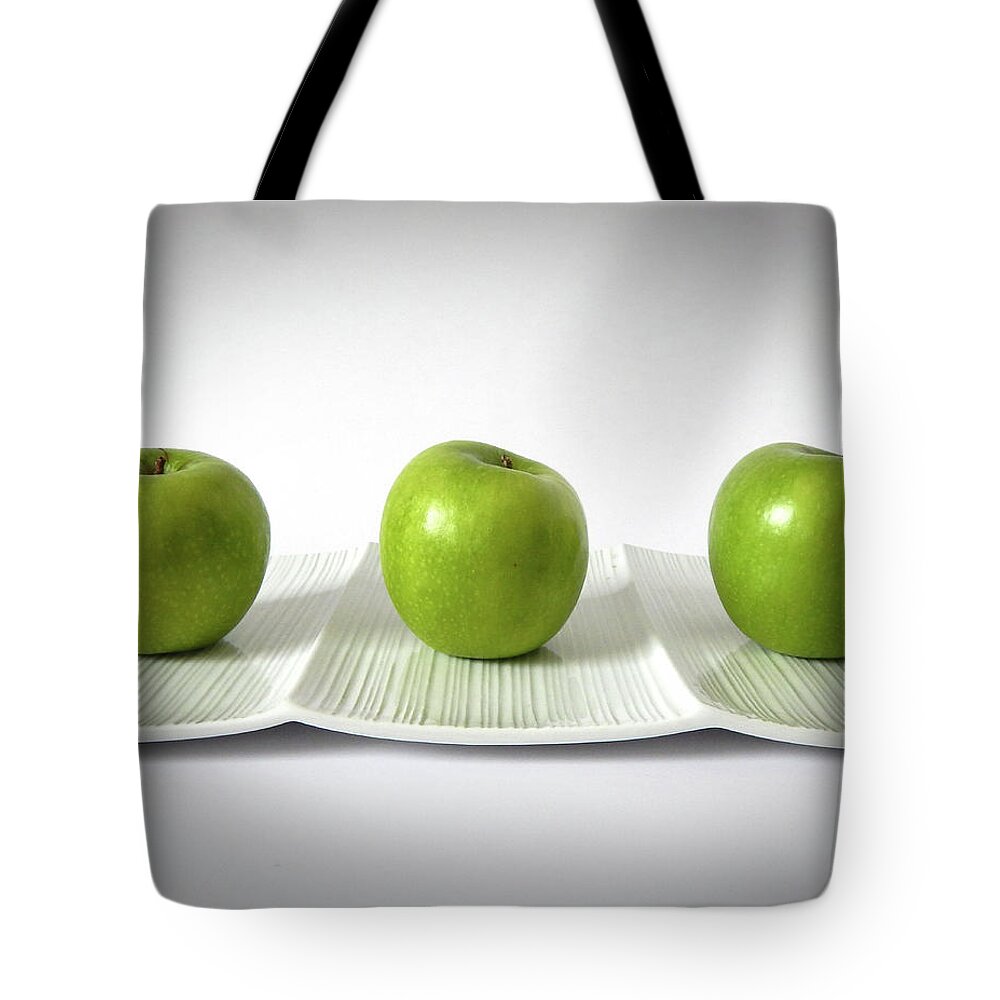 Apples Tote Bag featuring the photograph Three Green Apples by Lily Malor