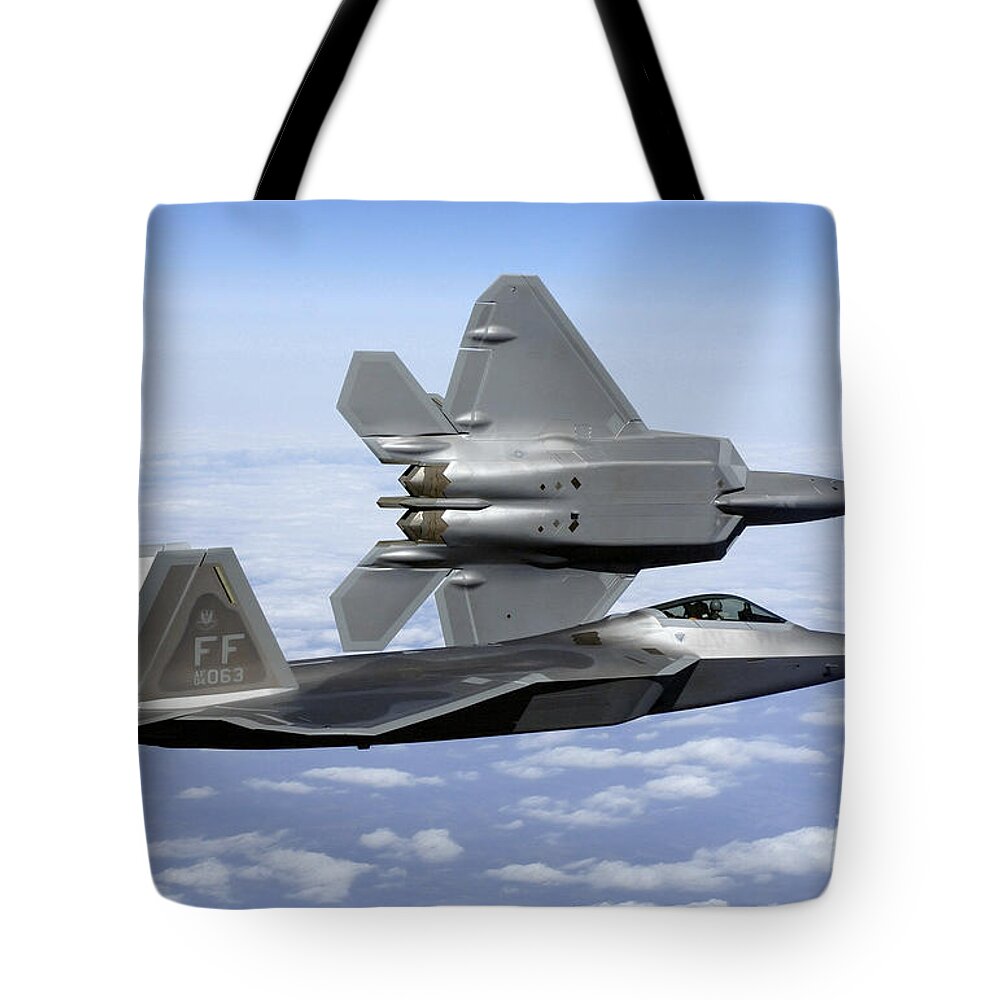 Aircraft Tote Bag featuring the photograph Two F-22a Raptors In Flight by Stocktrek Images