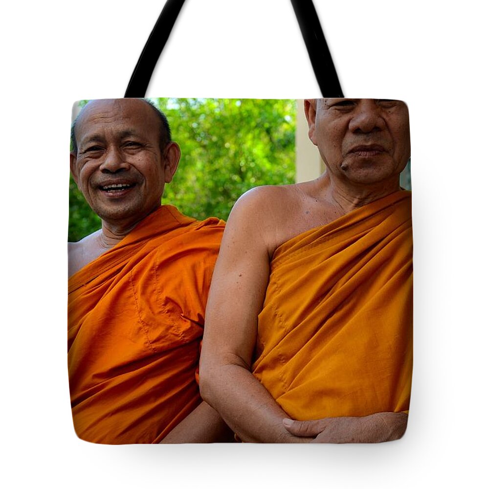 Monks Tote Bag featuring the photograph Two happy laughing Buddhist monks in robes Hat Yai Thailand by Imran Ahmed