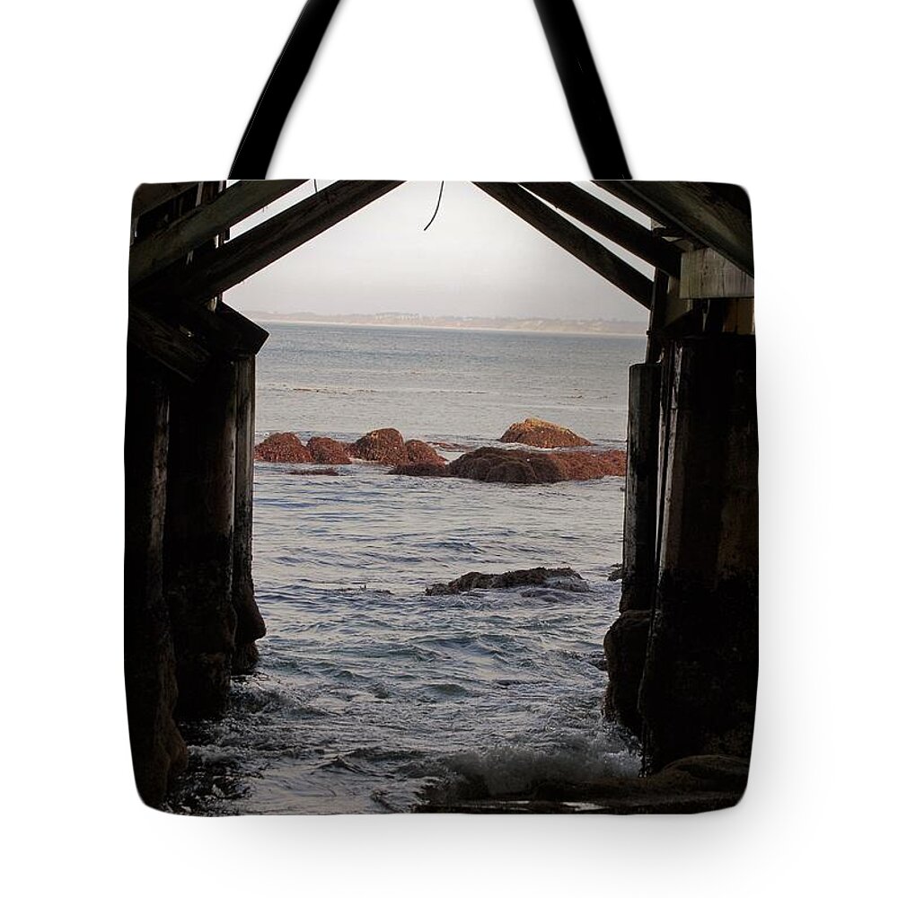 Water Tote Bag featuring the photograph Under the old jetty by Maria Aduke Alabi