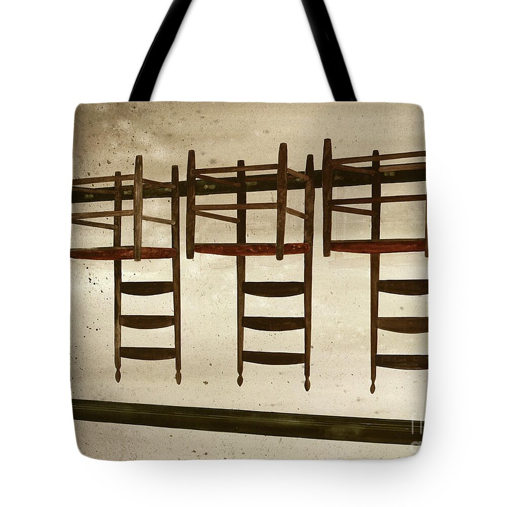 A Row Of Shaker Chairs Are Hung On Pegs Upside Down In The Center Family Dwelling At Pleasant Hill Shaker Village In Kentucky.  Tote Bag featuring the painting Upside Down by Monte Toon