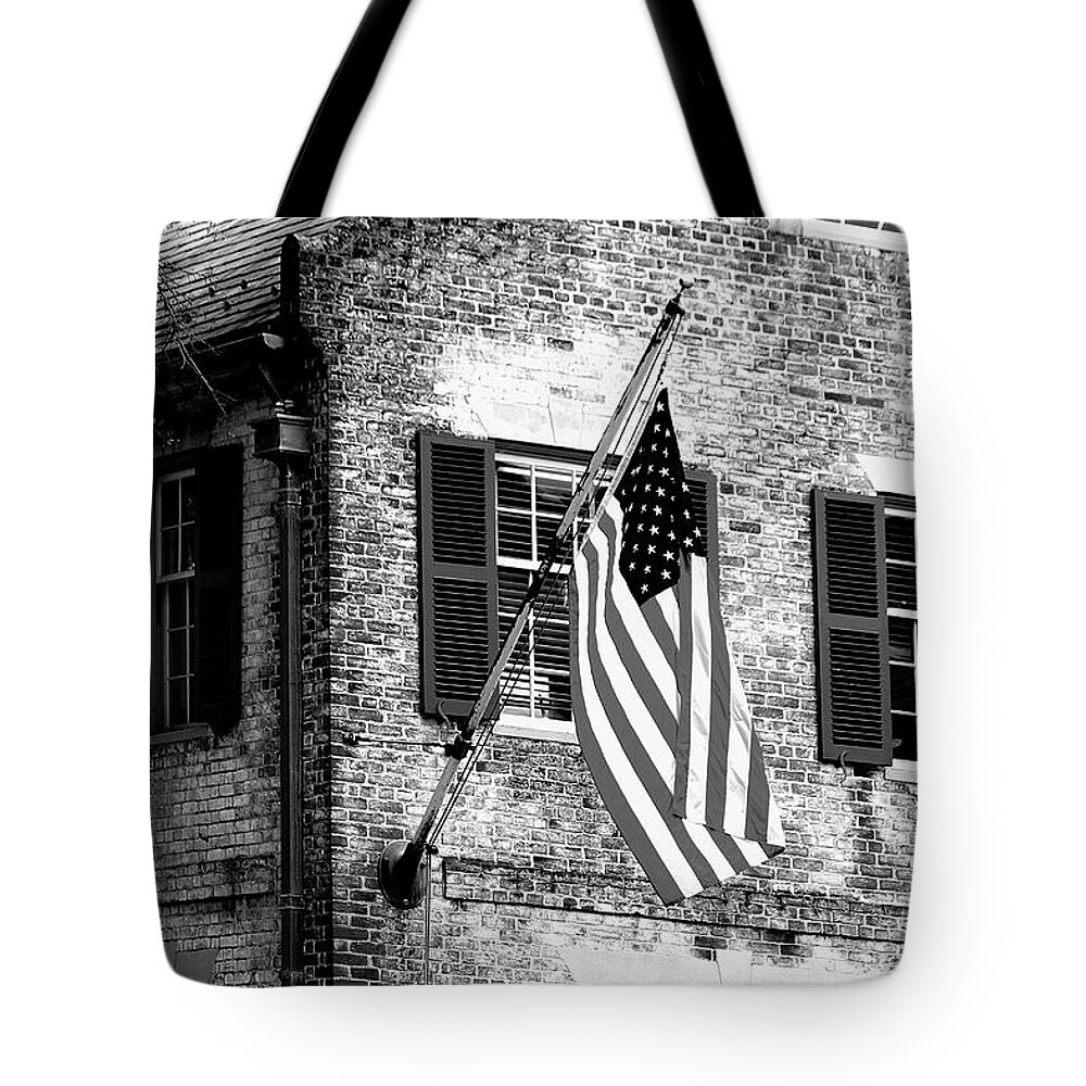 Colonial Tote Bag featuring the photograph US Flag in Colonial Williamsbug by Emanuel Tanjala
