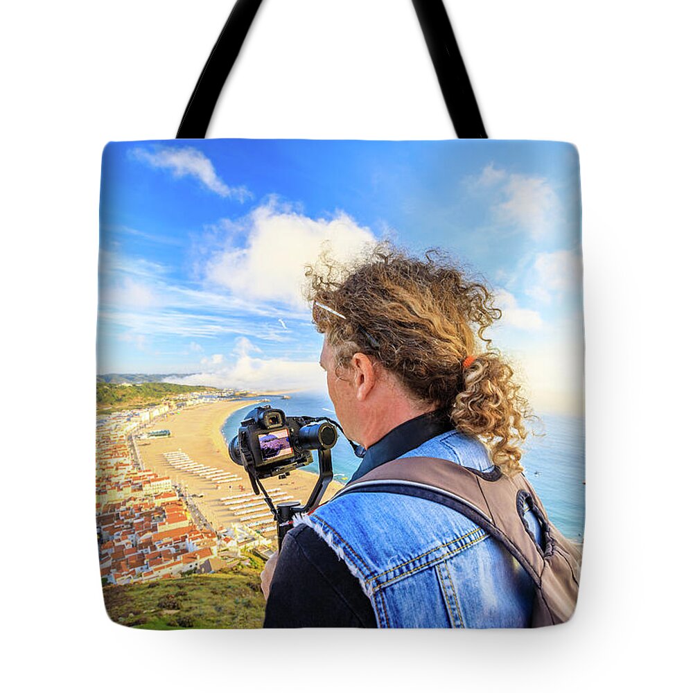 Nazare Portugal Tote Bag featuring the photograph Video photographer in Portugal by Benny Marty