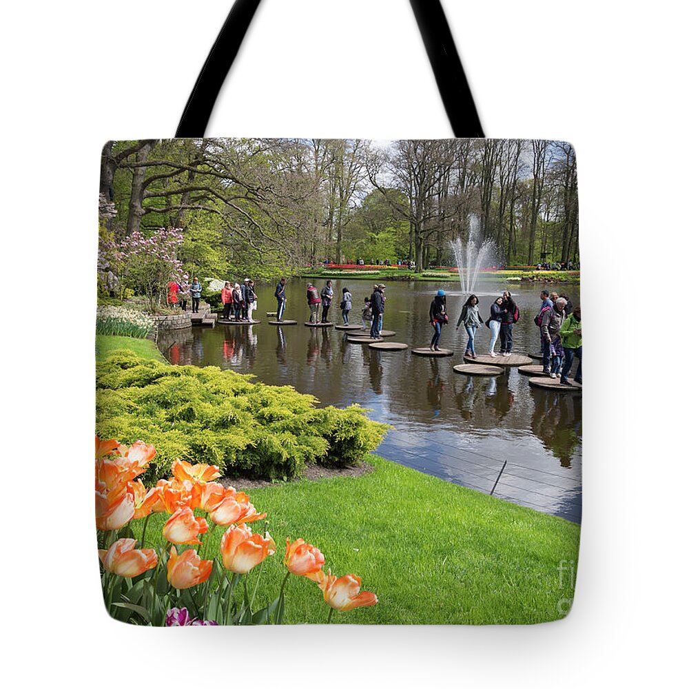 Stepping Stones Tote Bag featuring the photograph Visitors try the stepping stones at Keukenhof Gardens Holland by Louise Heusinkveld