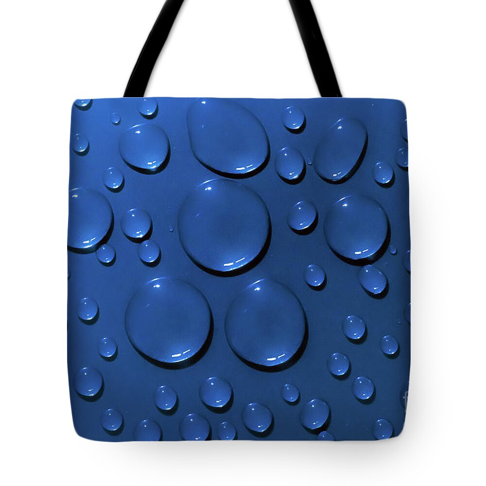 Water Tote Bag featuring the photograph Water drops pattern on blue background by Simon Bratt