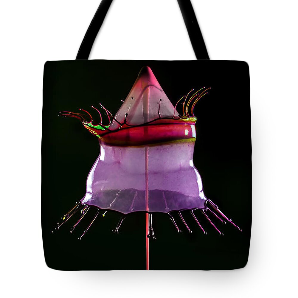 Liquid Tote Bag featuring the photograph Water sculpture in red and purple by Jaroslaw Blaminsky