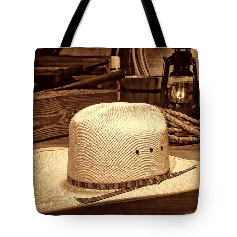 Cowboy Tote Bag featuring the photograph White Cowboy Hat in a Barn by American West Legend By Olivier Le Queinec