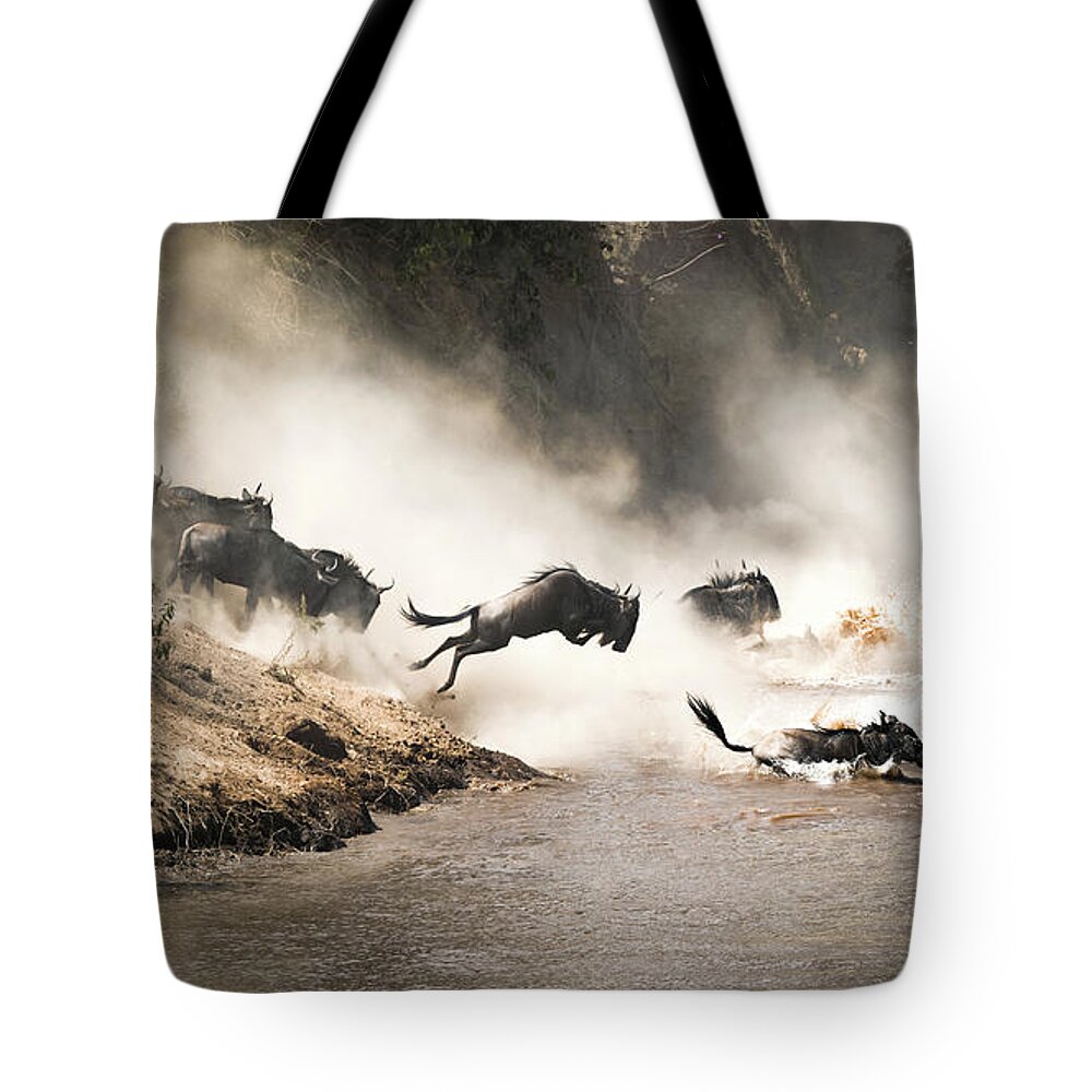 Mara Tote Bag featuring the photograph Wildebeest leap of faith into the Mara River by Jane Rix