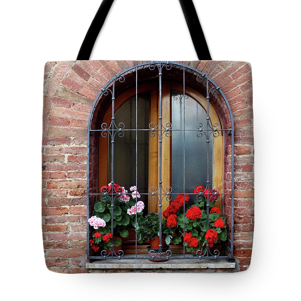 Window; Flower; Flowers; Brick; Arch; Ancient; Old; Wall; Pienza; Italy; Quaint; Pretty; Beautiful; Beauty; Lovely; Red; Pink; Historic; Iron Bar; Archway; Wood; House; Home; Potted Plant; Wrought Iron; Masonry; Renaissance; Town; Open Tote Bag featuring the photograph Window in Pienza by Adam Long