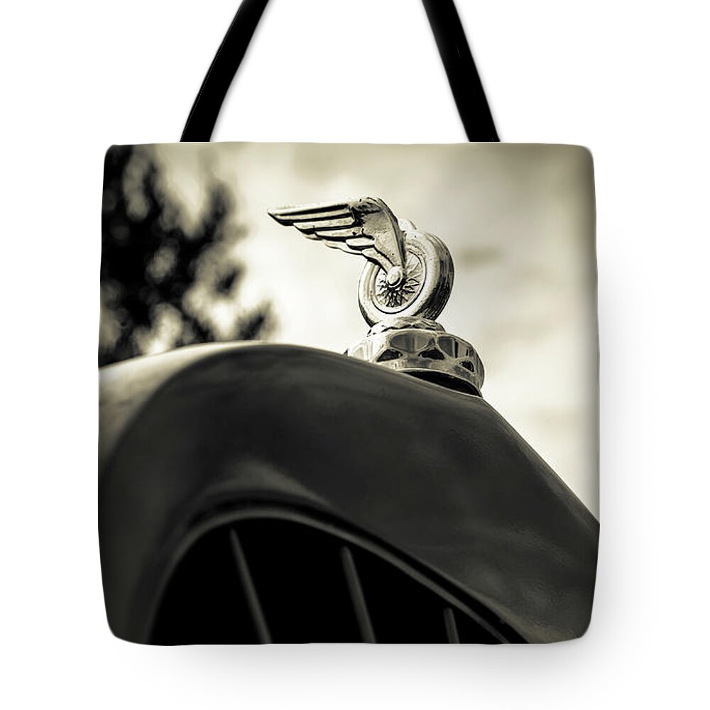 Hood Ornament Tote Bag featuring the photograph Winged Wheel by Caitlyn Grasso