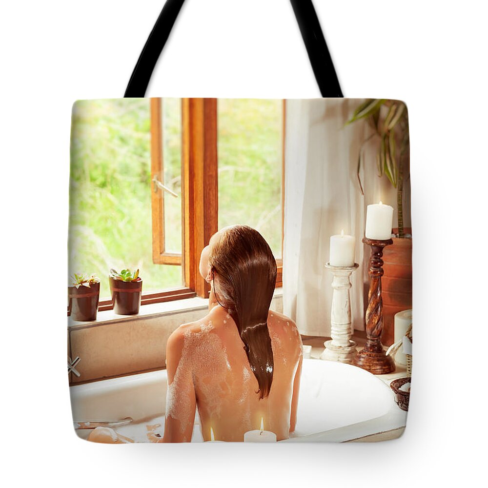 Bath Tote Bag featuring the photograph Woman relaxing in the bath by Anna Om