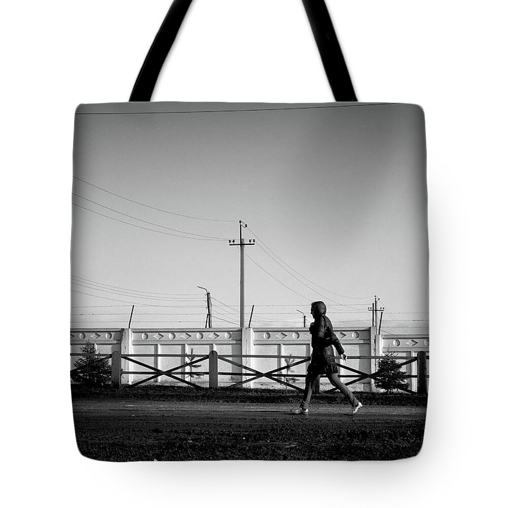Woman Walking Tote Bag featuring the photograph Woman Walking in Industry by John Williams