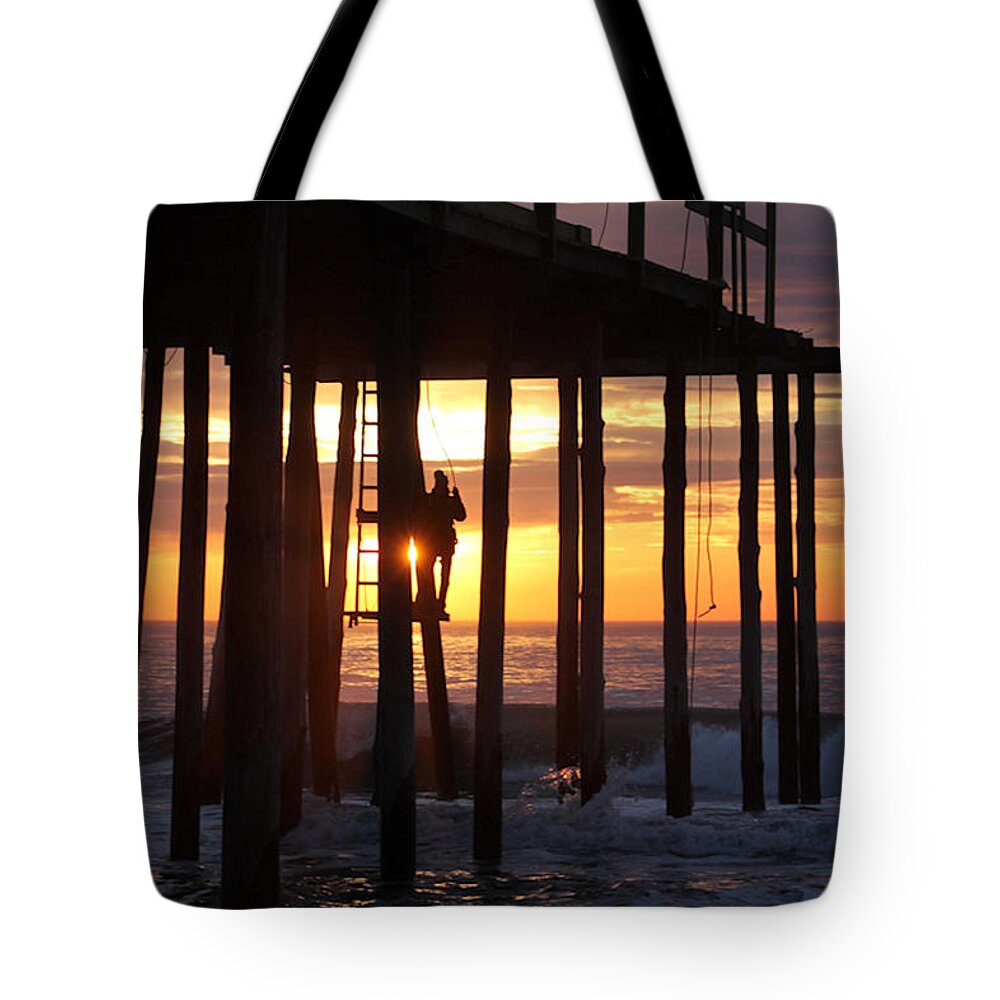 Work Tote Bag featuring the photograph Working On The Pier At Dawn by Robert Banach