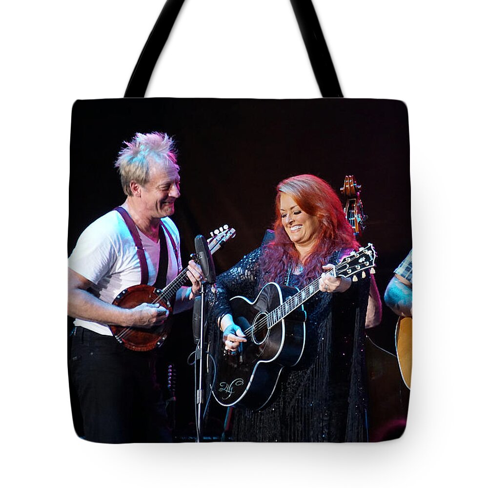 Wynonna Judd Tote Bag featuring the photograph Wynonna Judd In Concert With Hubby Cactus Moser and Band Guitarist by Mick Anderson