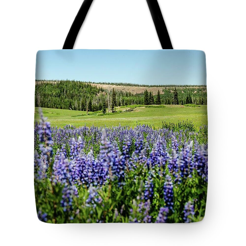 Silvery Lupine Tote Bag featuring the photograph Yard full of wildflowers by Gaelyn Olmsted