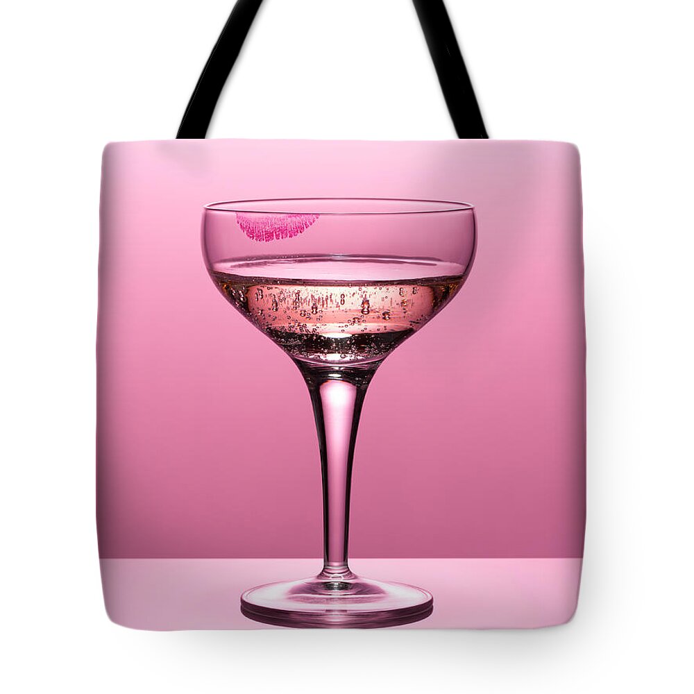 Temptation Tote Bag featuring the photograph Close Up Of Pink Champagne In Glass #1 by Andy Roberts