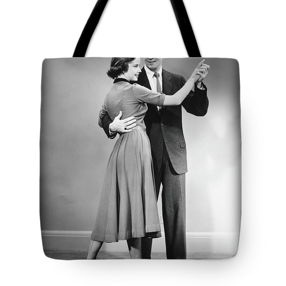 Young Men Tote Bag featuring the photograph Couple Dancing In Studio, B&w #1 by George Marks
