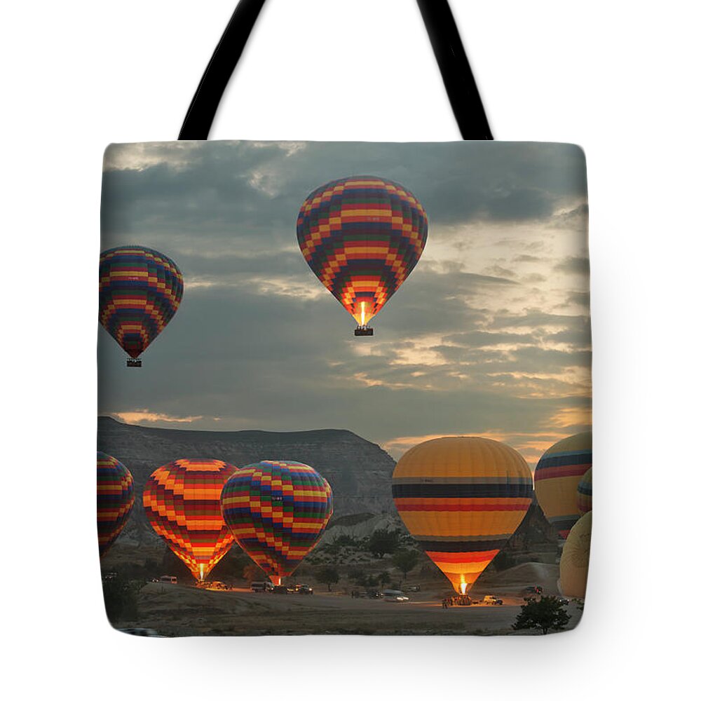 Dawn Tote Bag featuring the photograph Early Morning Hot Air Balloons In #1 by Izzet Keribar