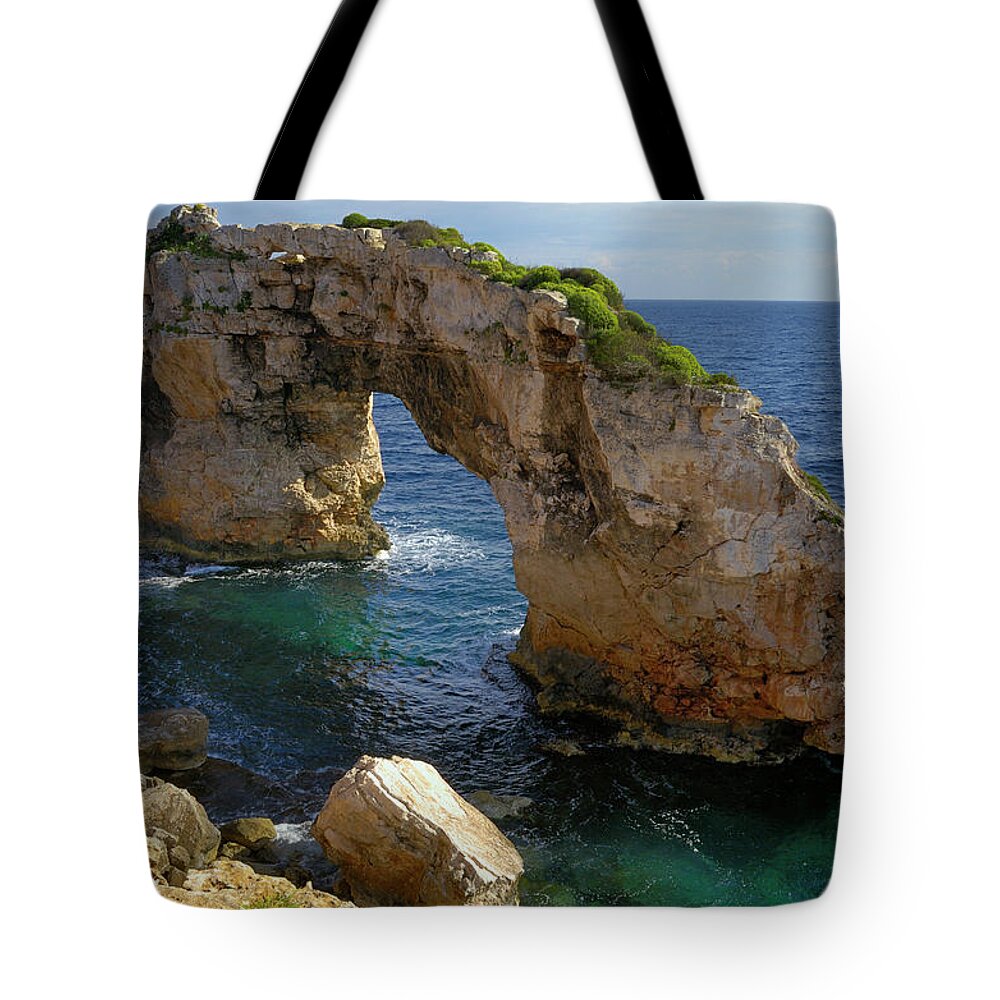 Tranquility Tote Bag featuring the photograph Es Pontas, A Natural Rock Arch In The #1 by Cornelia Doerr