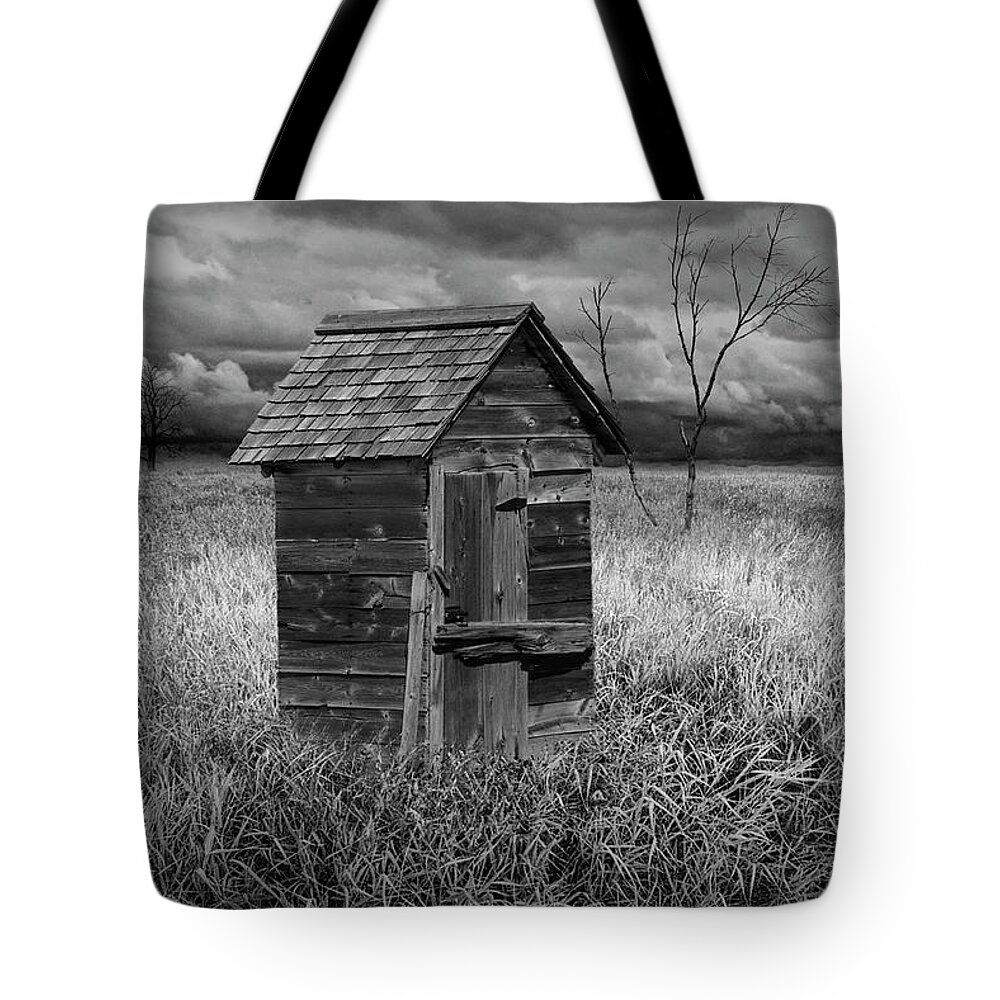 Rural Tote Bag featuring the photograph Rural Outhouse langishing in the Countryside #1 by Randall Nyhof