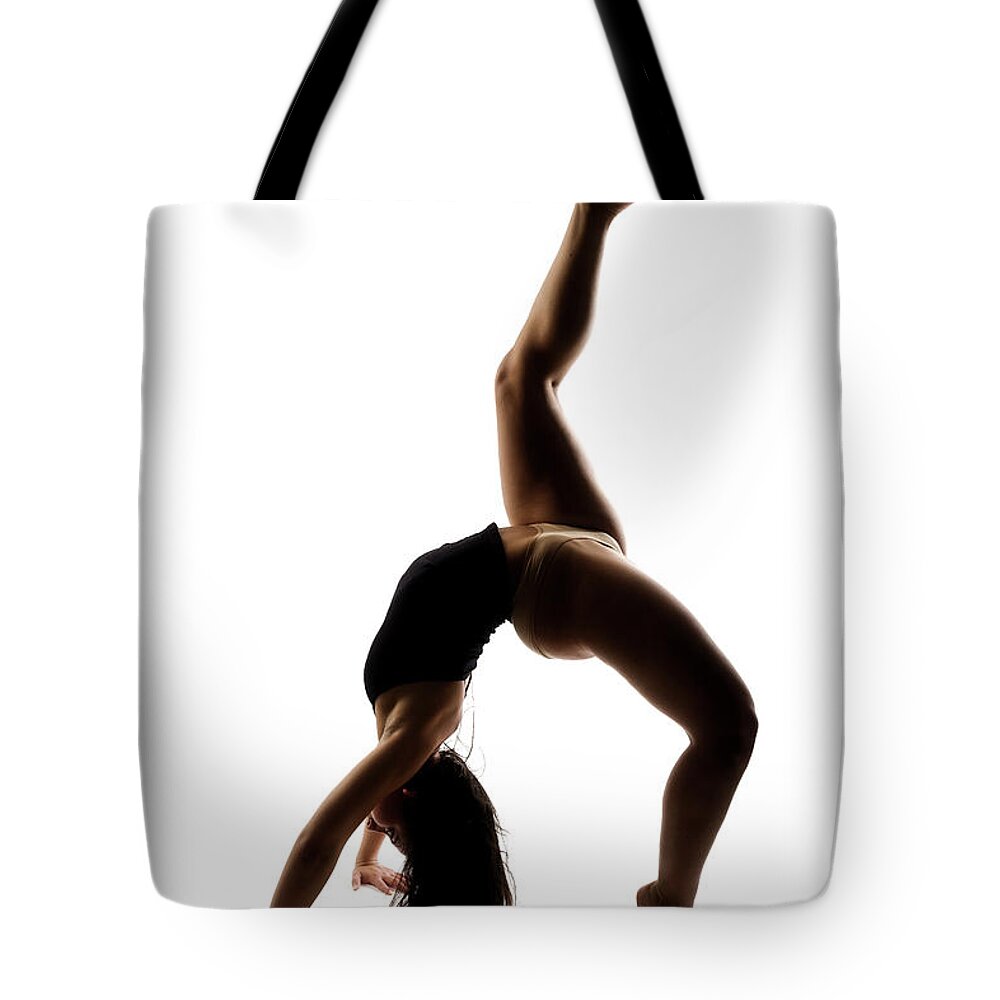 Ballet Dancer Tote Bag featuring the photograph Silhouette Of A Performing Dancer #1 by Opla