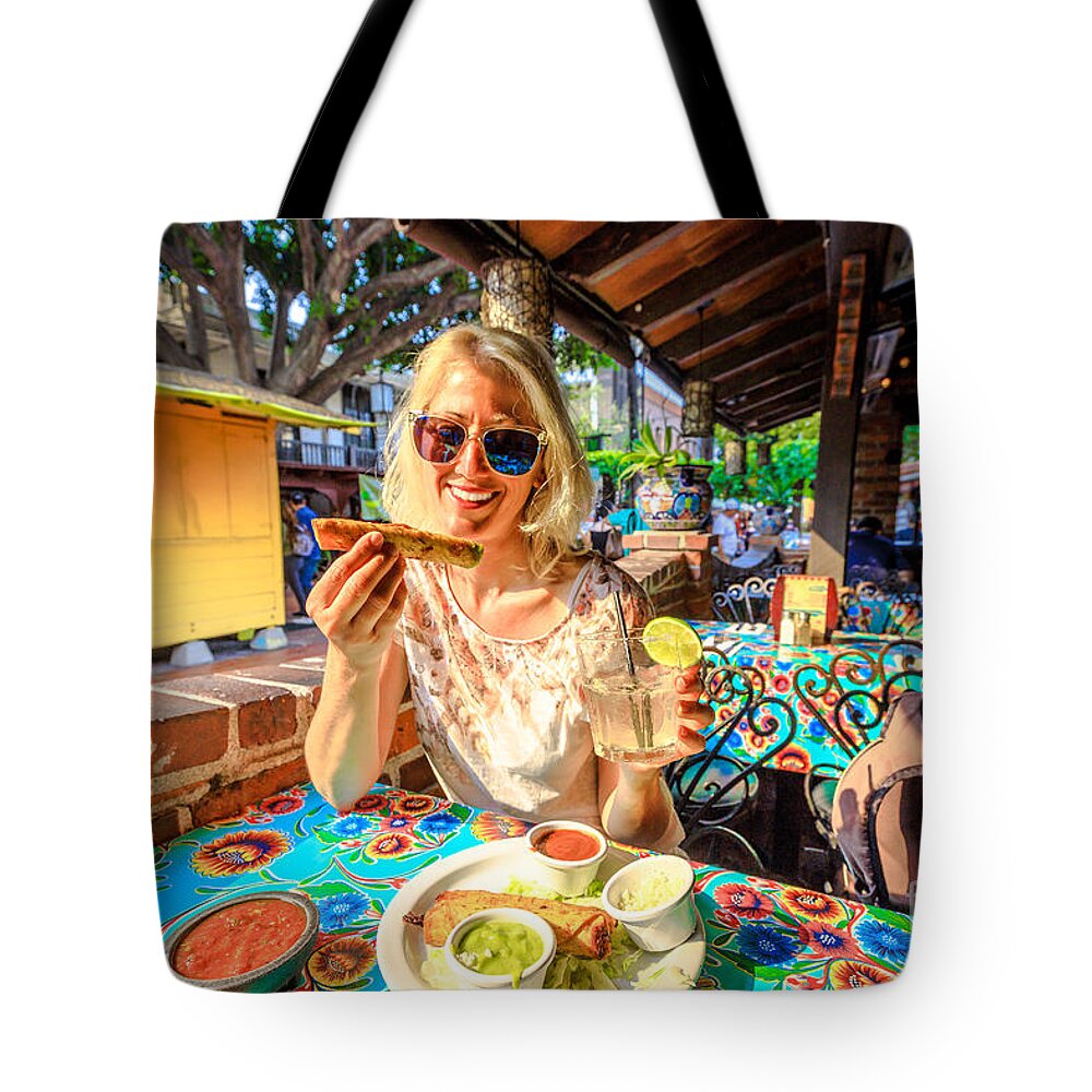 Los Angeles Tote Bag featuring the photograph Tourist woman at El Pueblo #1 by Benny Marty