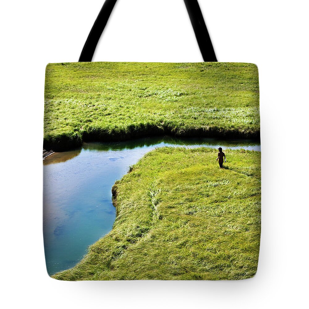 Young Men Tote Bag featuring the photograph Two Young Men Hike Through A Grassy #1 by Patrick Orton
