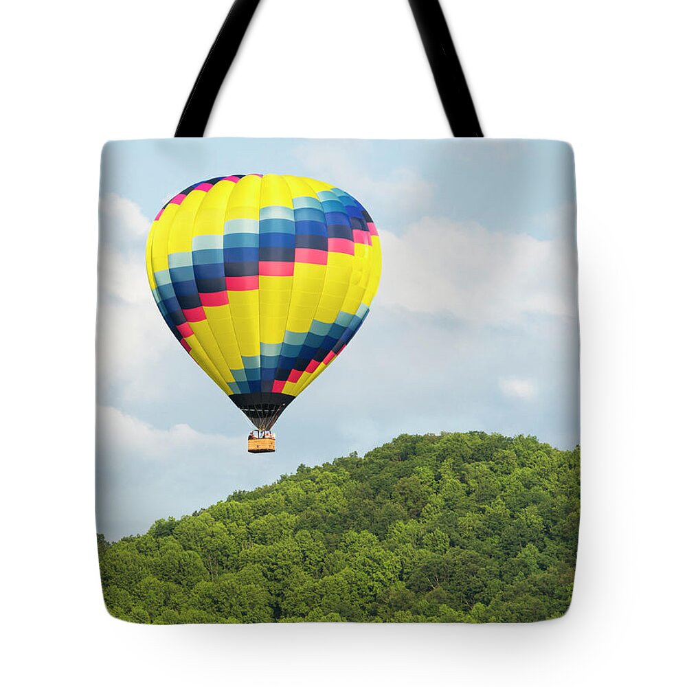 Recreational Pursuit Tote Bag featuring the photograph Hot Air Balloon In A Blue Sky #2 by Wbritten