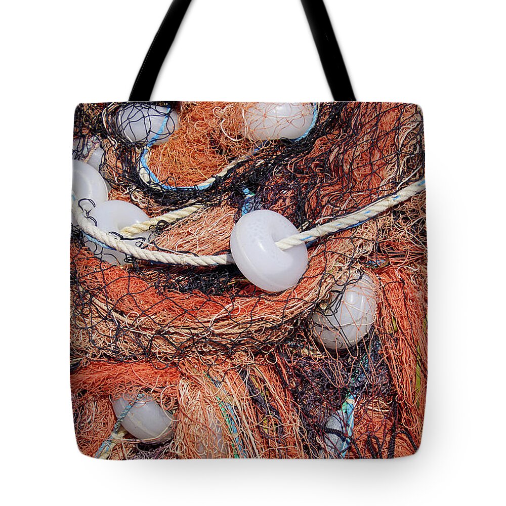 Assos Tote Bag featuring the photograph Multi-colored nylon fishing nets and floats #3 by Steve Estvanik