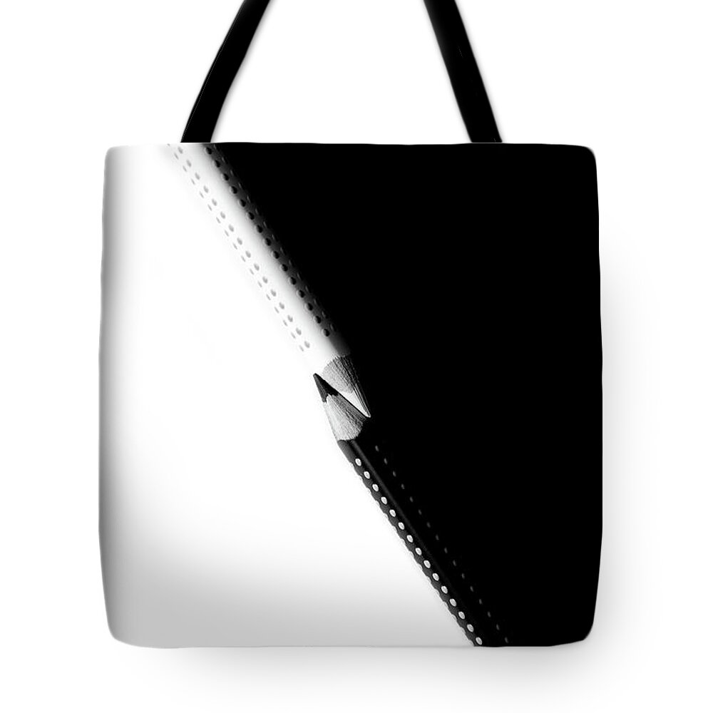 Education Tote Bag featuring the photograph Two drawing pencils on a black and white surface. by Michalakis Ppalis