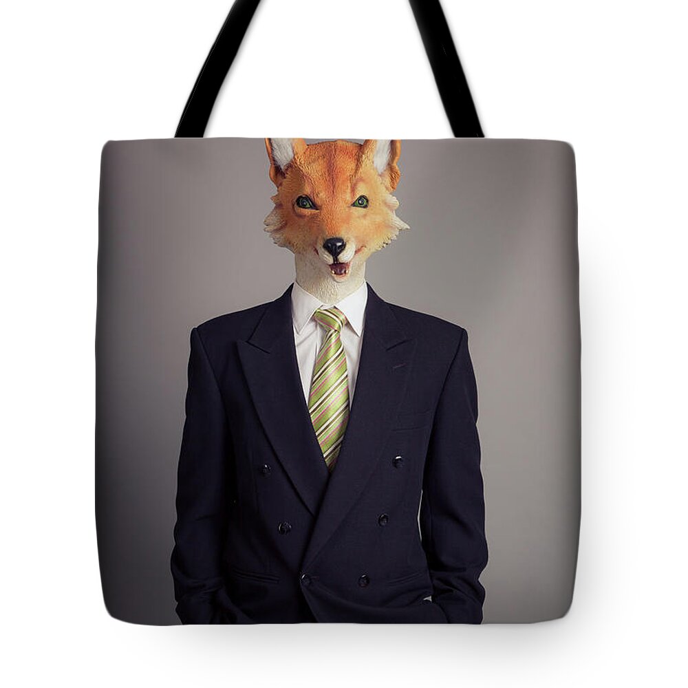 People Tote Bag featuring the photograph A Human Figure With A Fox Head Wearing by Trevor Williams
