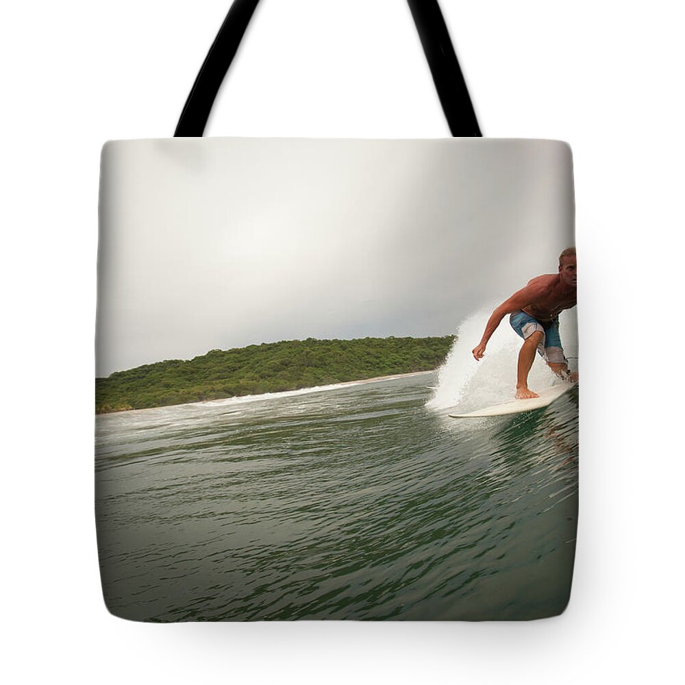 Focus Tote Bag featuring the photograph A Male Surfer In A Barrel Of A Wave In by Sean Murphy