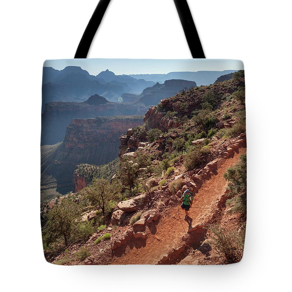 Tranquility Tote Bag featuring the photograph A Man Hiking On A Trail With Canyons In by Whit Richardson