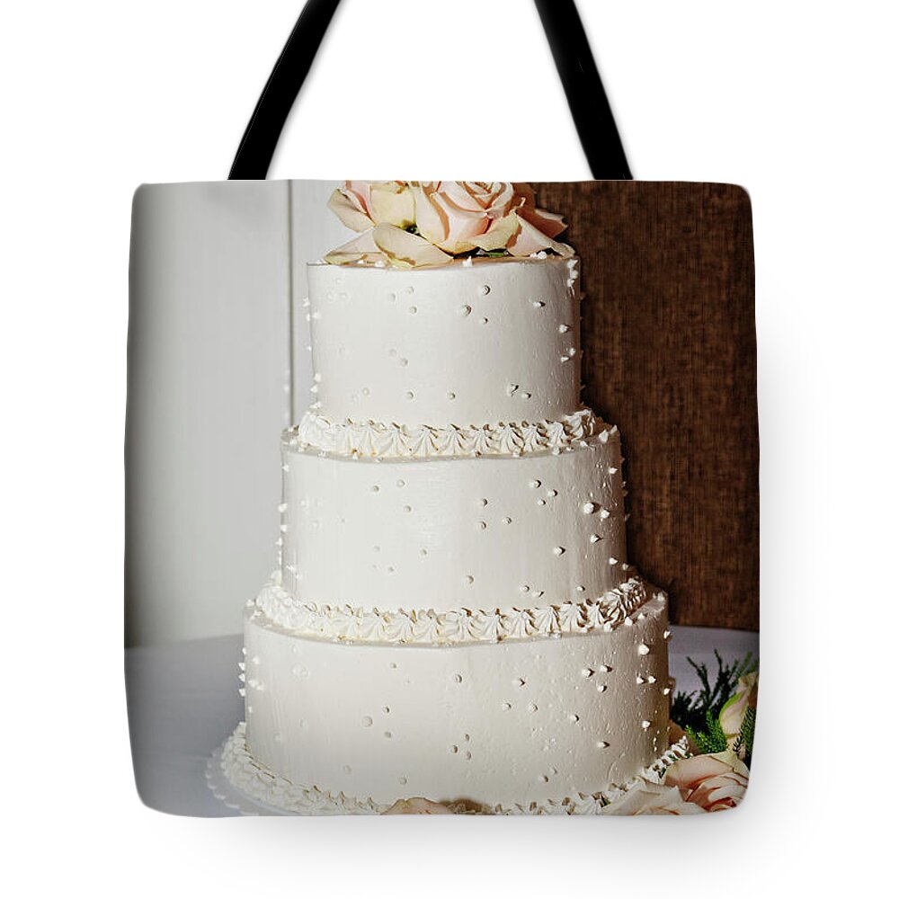 Temptation Tote Bag featuring the photograph A Wedding Cake Trimed In Peach Roses by Driendl Group