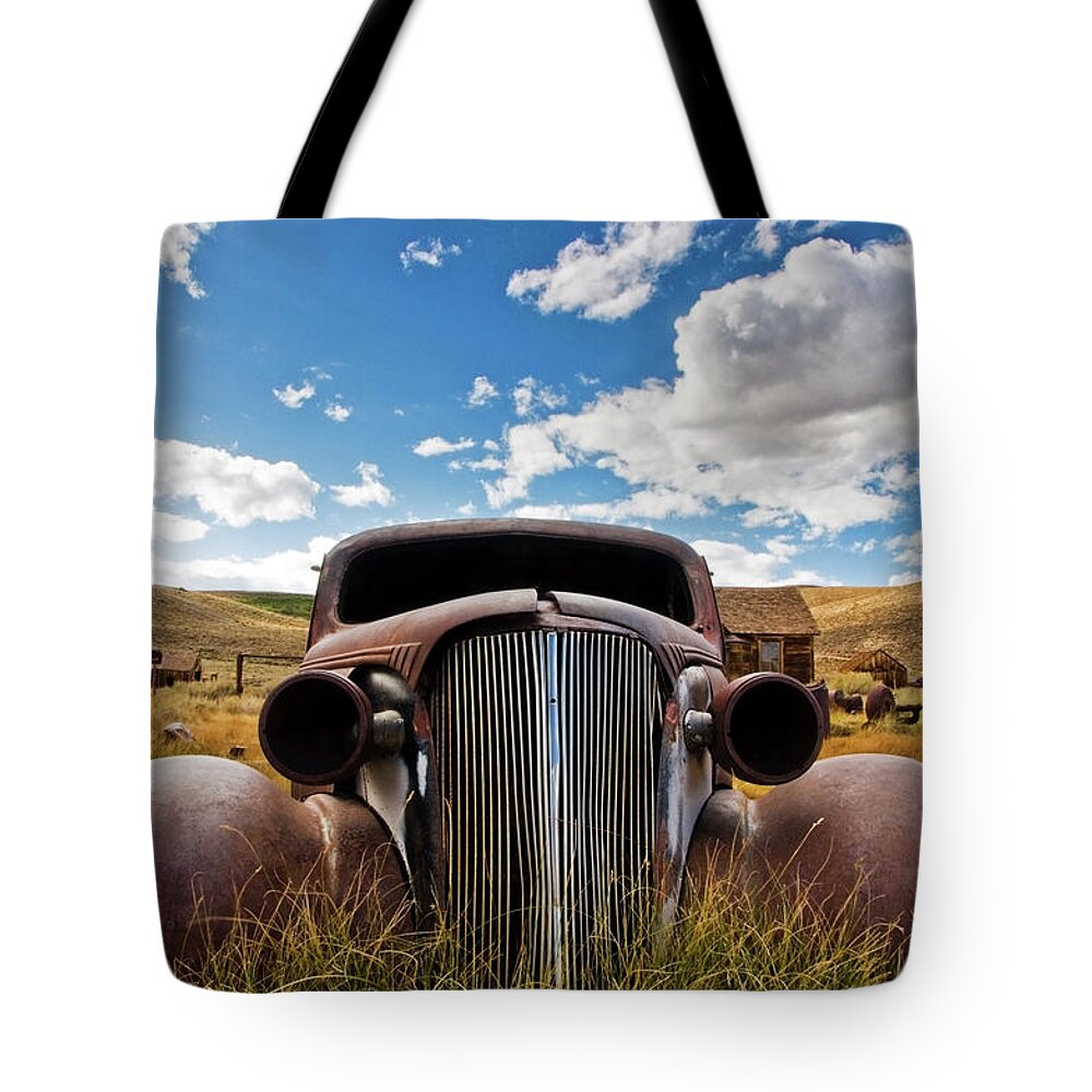 19th Century Style Tote Bag featuring the photograph An Old Abandoned Car Rusts Away In The by Rachid Dahnoun