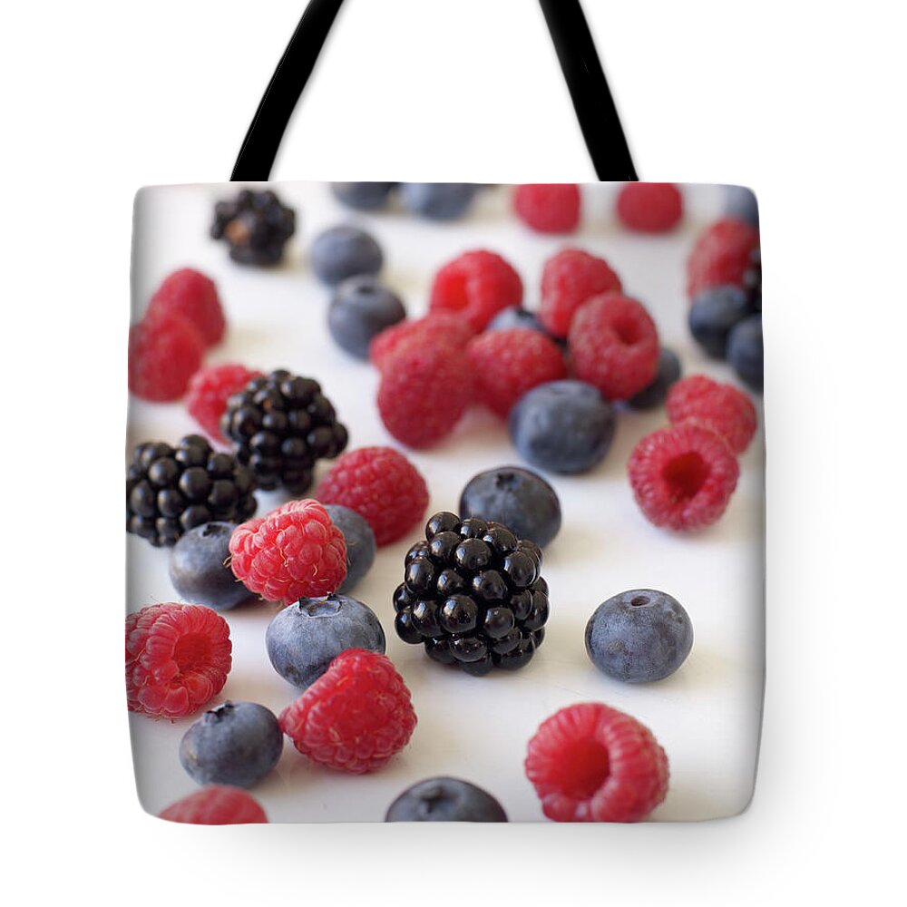 White Background Tote Bag featuring the photograph Assorted Berries by James Baigrie