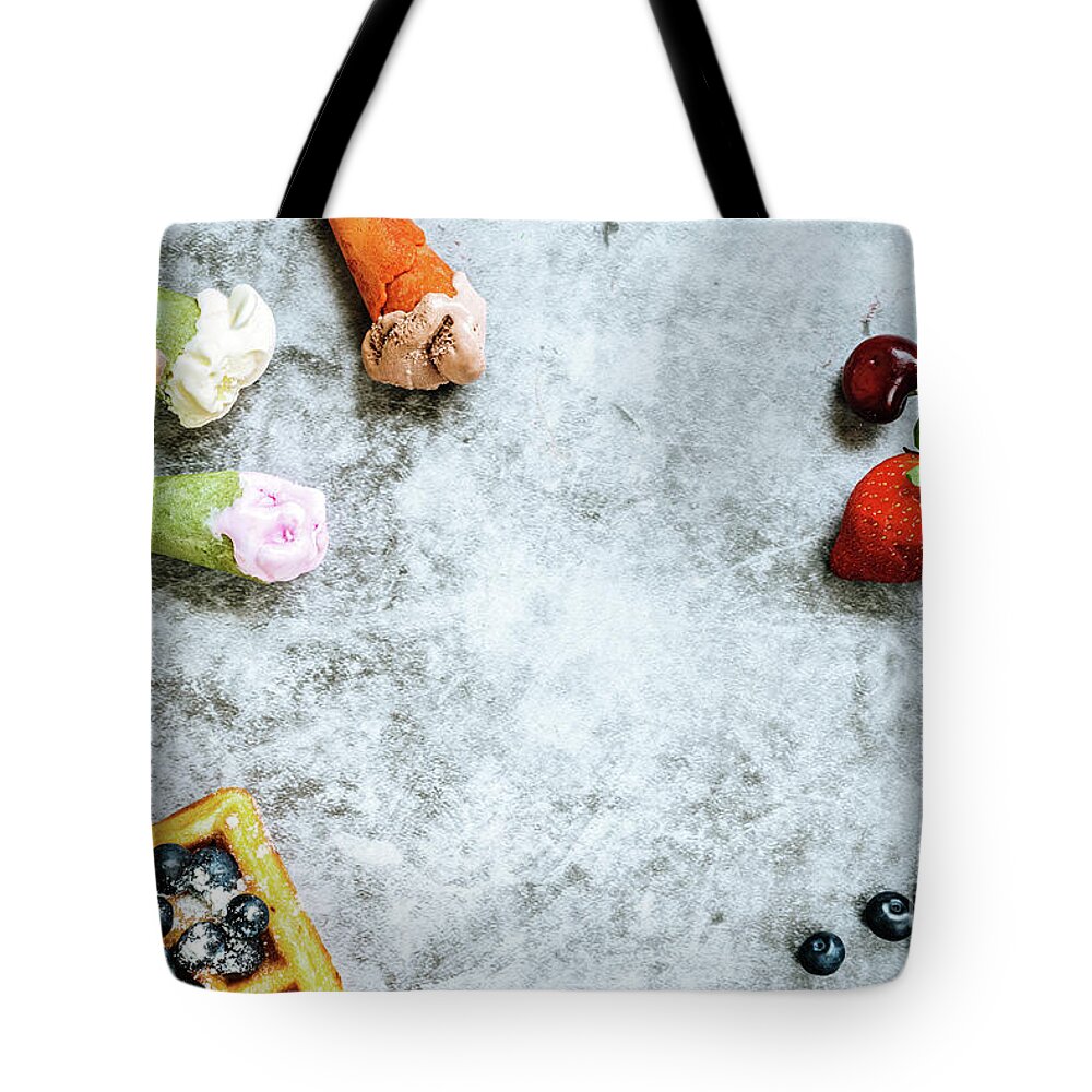 Above Tote Bag featuring the photograph Background of tasty and sweet foods with red fruits and waffles, by Joaquin Corbalan