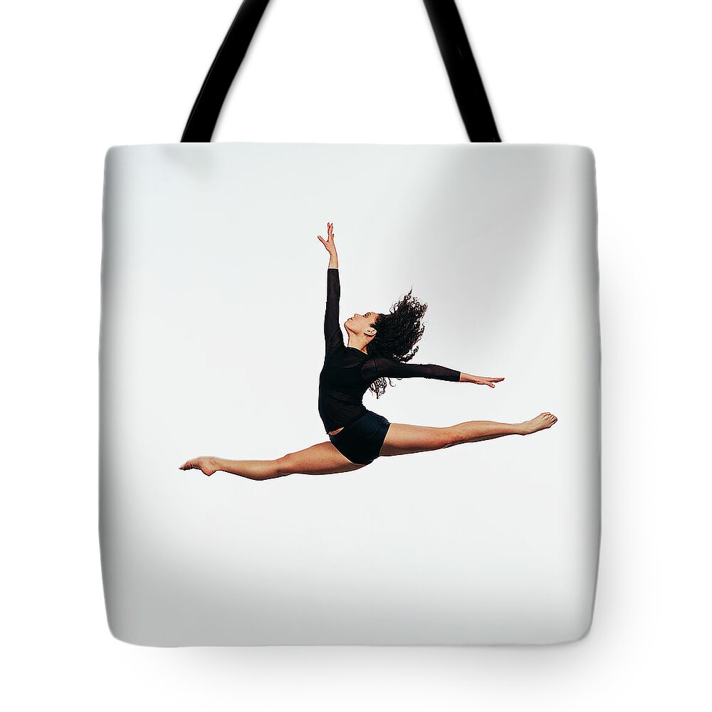 Ballet Dancer Tote Bag featuring the photograph Ballet Dancer Doing The Splits In Mid by Chris Nash